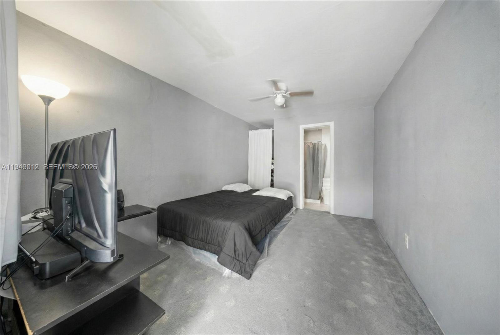 6971 Southwest 24th Street Miramar, FL 33023 - Photo 22 of 22 a living room with a bed furniture and a window