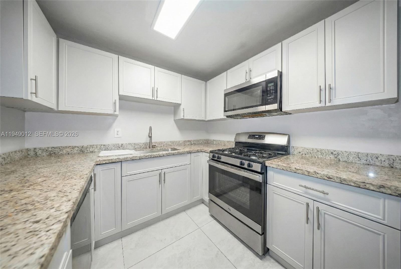 6971 Southwest 24th Street Miramar, FL 33023 - Photo 9 of 22 a kitchen with granite countertop cabinets stainless steel appliances and a sink