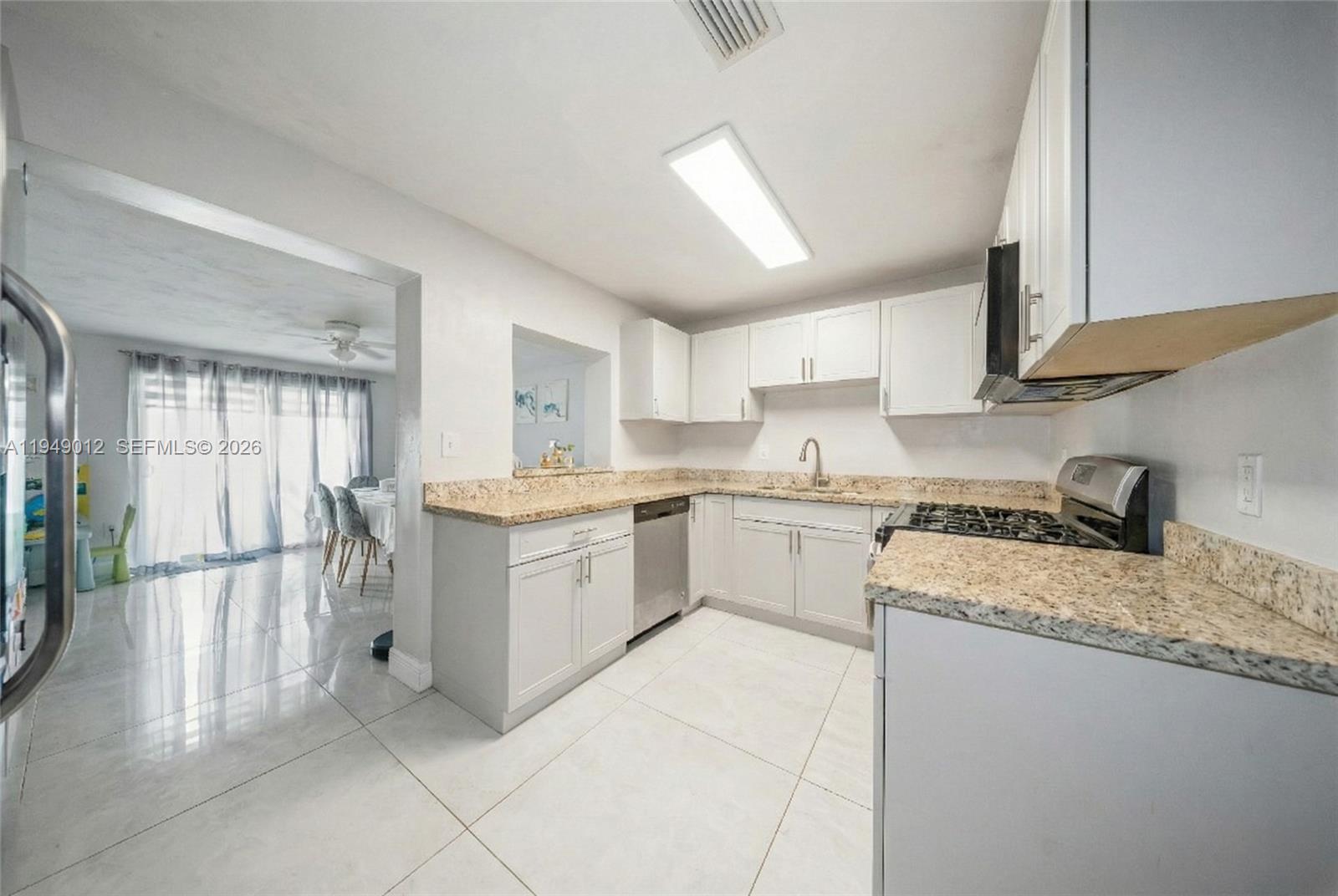 6971 Southwest 24th Street Miramar, FL 33023 - Photo 10 of 22 a kitchen with a refrigerator sink and cabinets