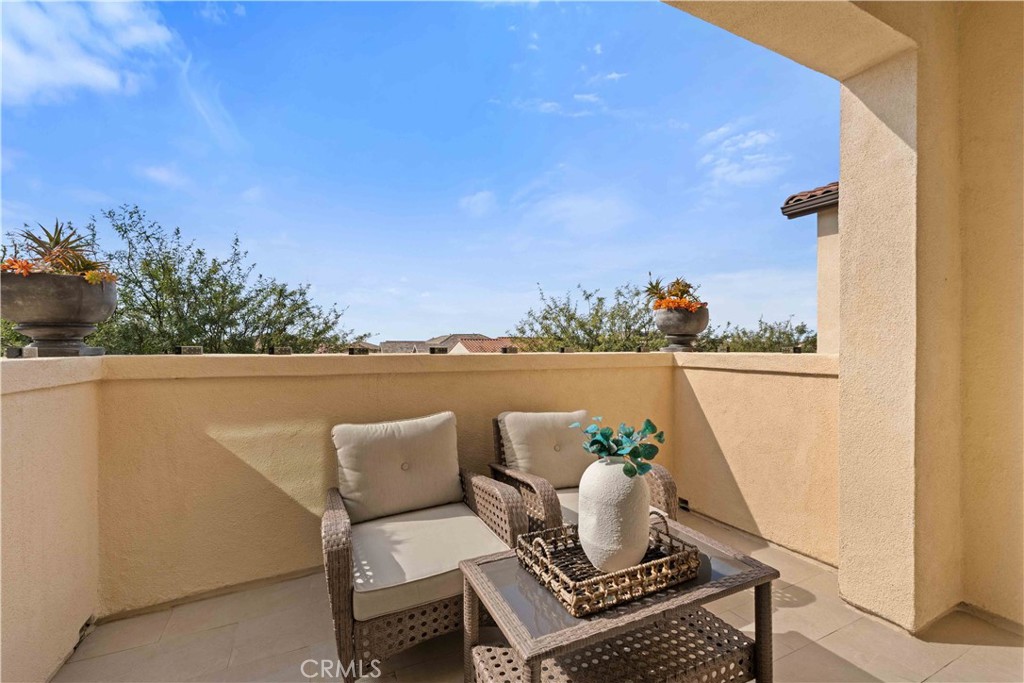 135 Alder Ridge Lake Forest, CA 92610 - Photo 12 of 30 a balcony with wooden floor and outdoor seating