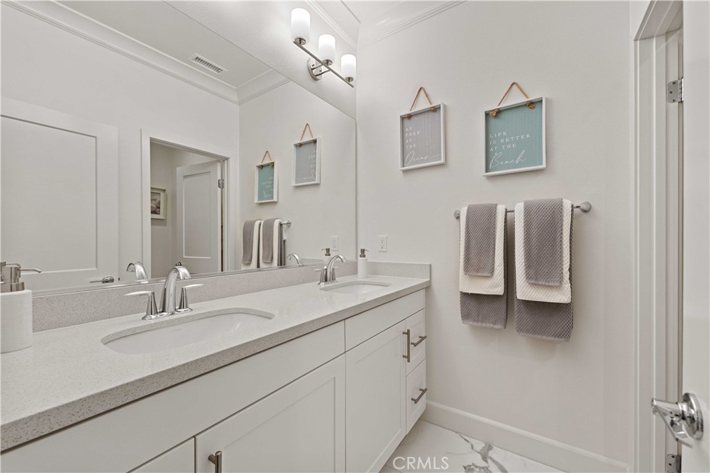 135 Alder Ridge Lake Forest, CA 92610 - Photo 24 of 30 a bathroom with a double vanity sink a mirror and a shower