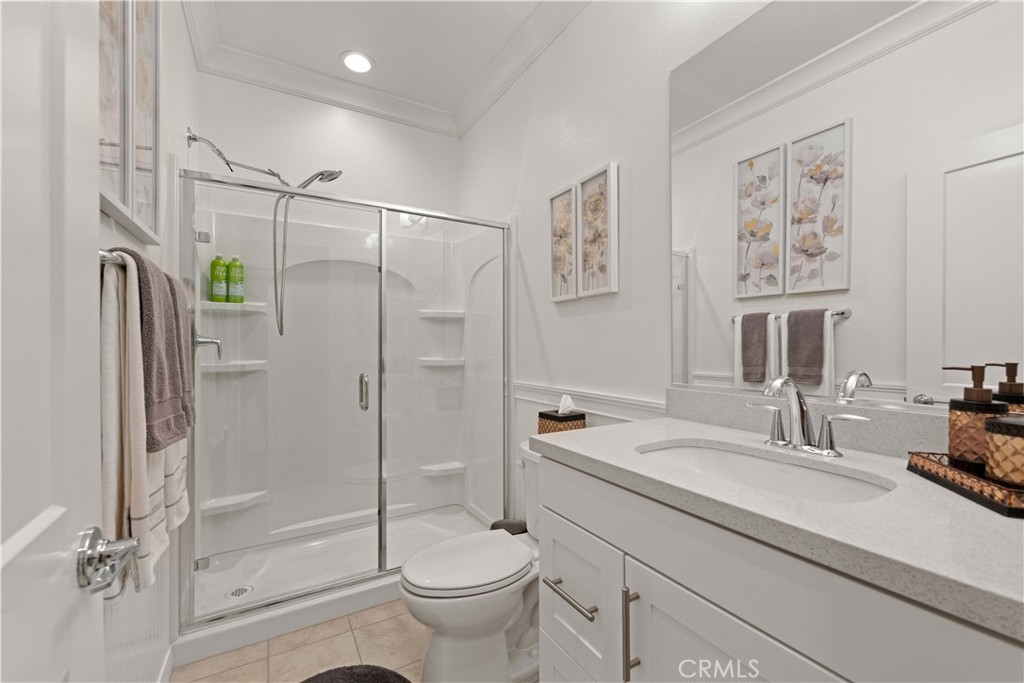 135 Alder Ridge Lake Forest, CA 92610 - Photo 5 of 30 a bathroom with a shower sink vanity mirror and toilet