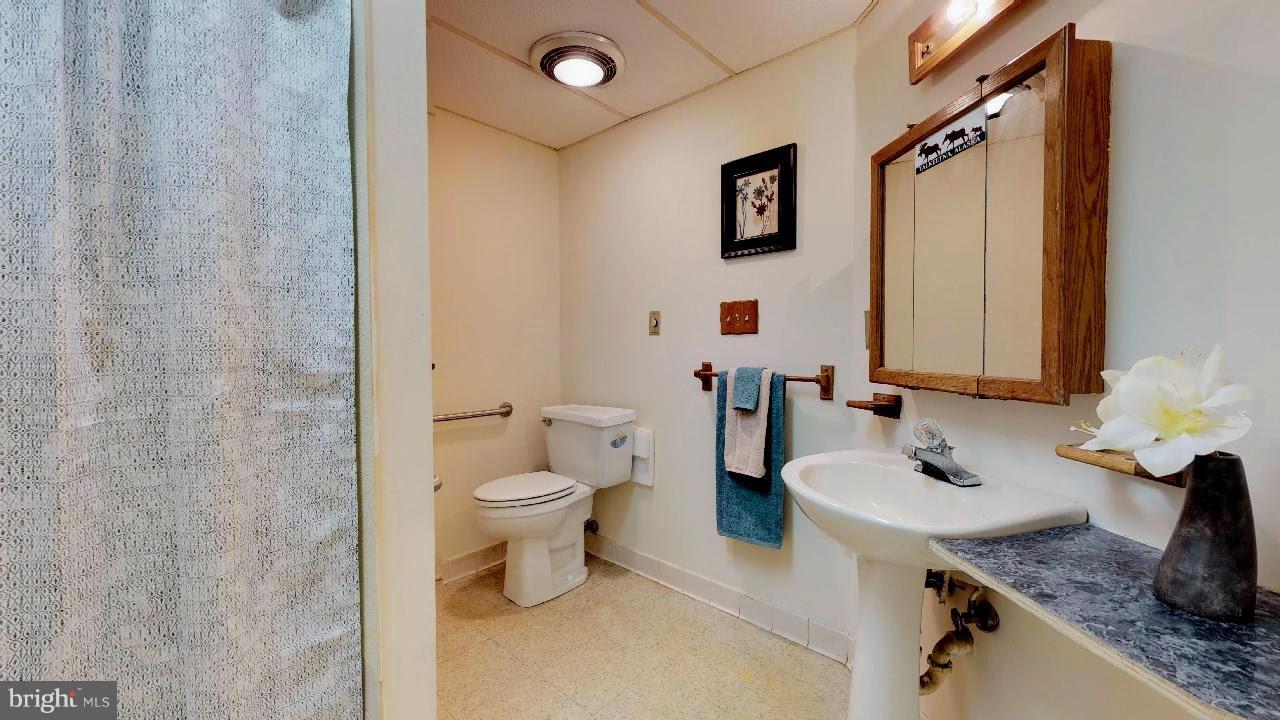 11730 Perry Branch Road Newburg, MD 20664 - Photo 23 of 27 a bathroom with a granite countertop sink mirror vanity and toilet