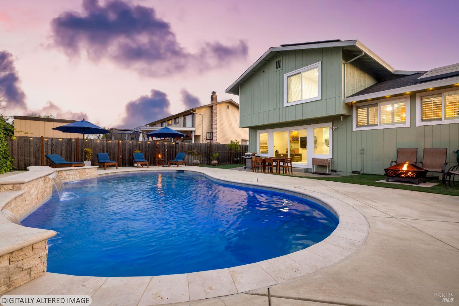 a view of a house with swimming pool in front of it