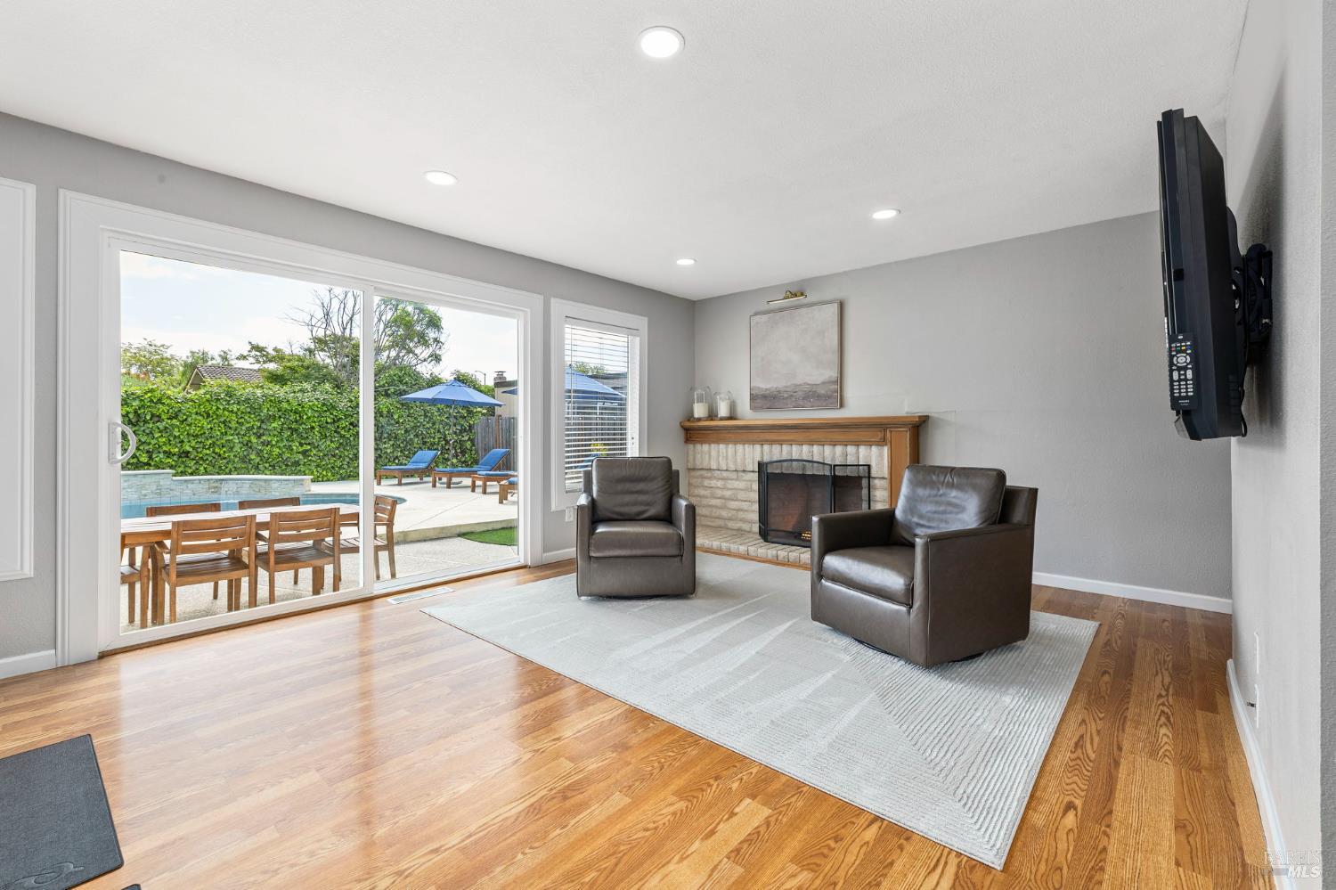 5328 Daniel Drive Rohnert Park, CA 94928 - Photo 16 of 42 a living room with furniture a fireplace and a floor to ceiling window