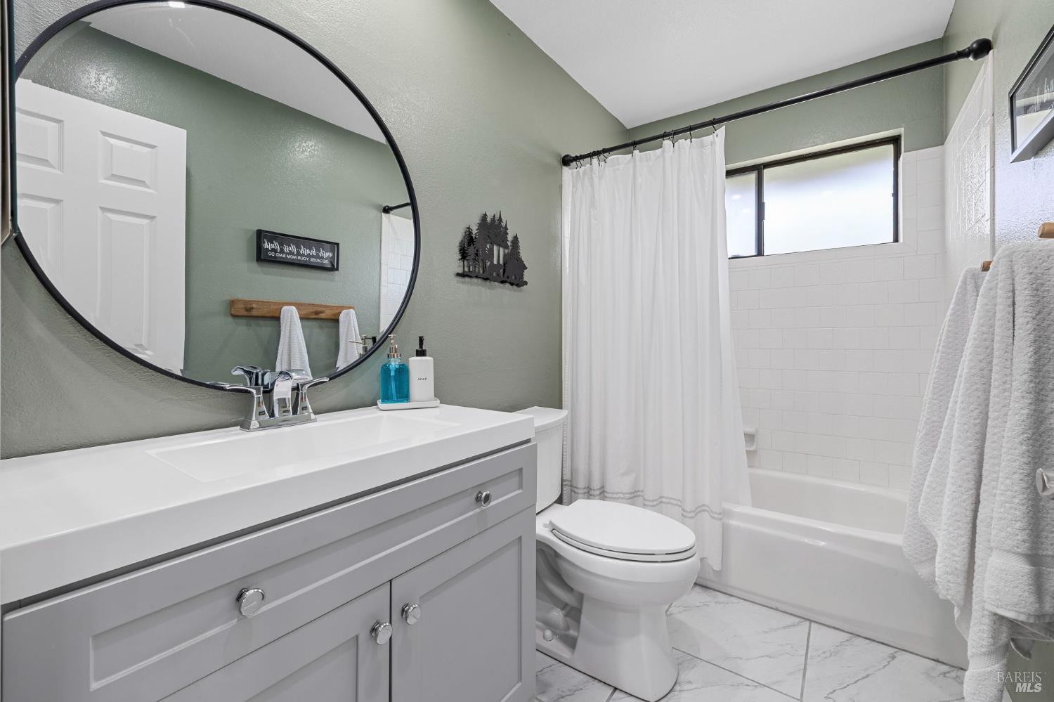 5328 Daniel Drive Rohnert Park, CA 94928 - Photo 19 of 42 a bathroom with a toilet a sink and a mirror