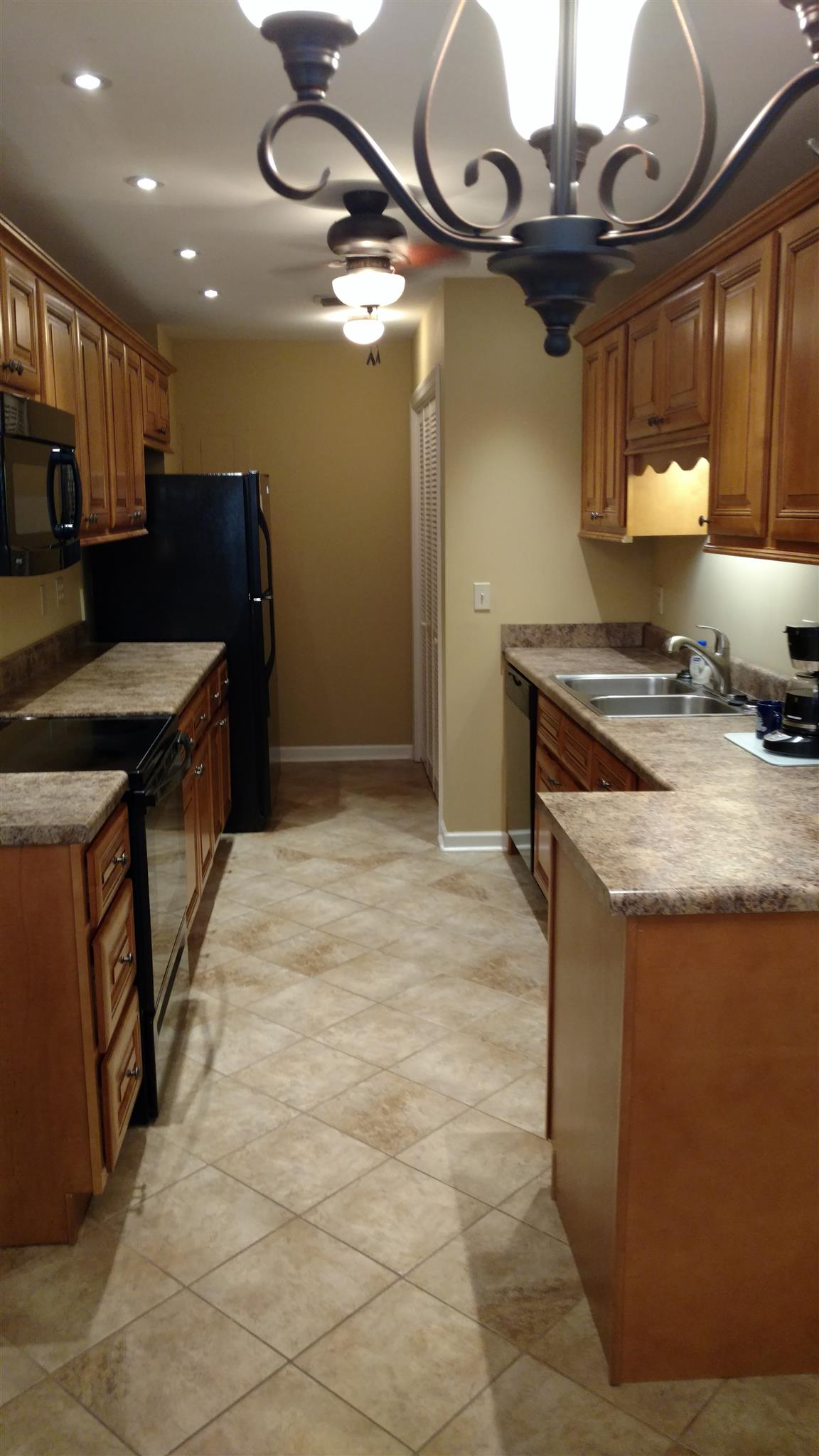 1246 General George Patton Road, Unit 1246 Nashville, TN 37221 - Photo 3 of 7 a kitchen with a stove and a sink