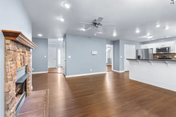 wooden floor in an empty room with a kitchen