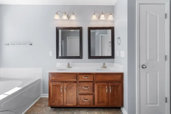 a bathroom with a double vanity sink and a mirror