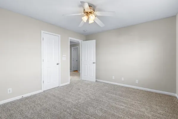a view of a room with a ceiling fan and a chandelier fan
