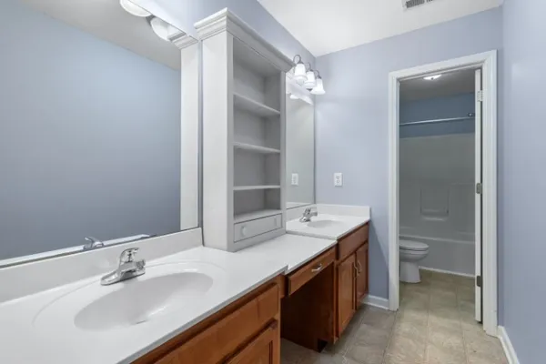 a bathroom with a double vanity sink and a mirror