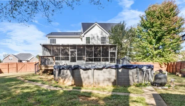 a view of a house with backyard and sitting area