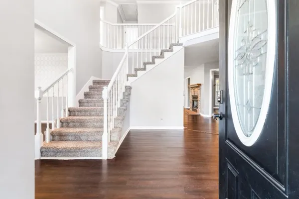 a view of entryway and hall with wooden floor