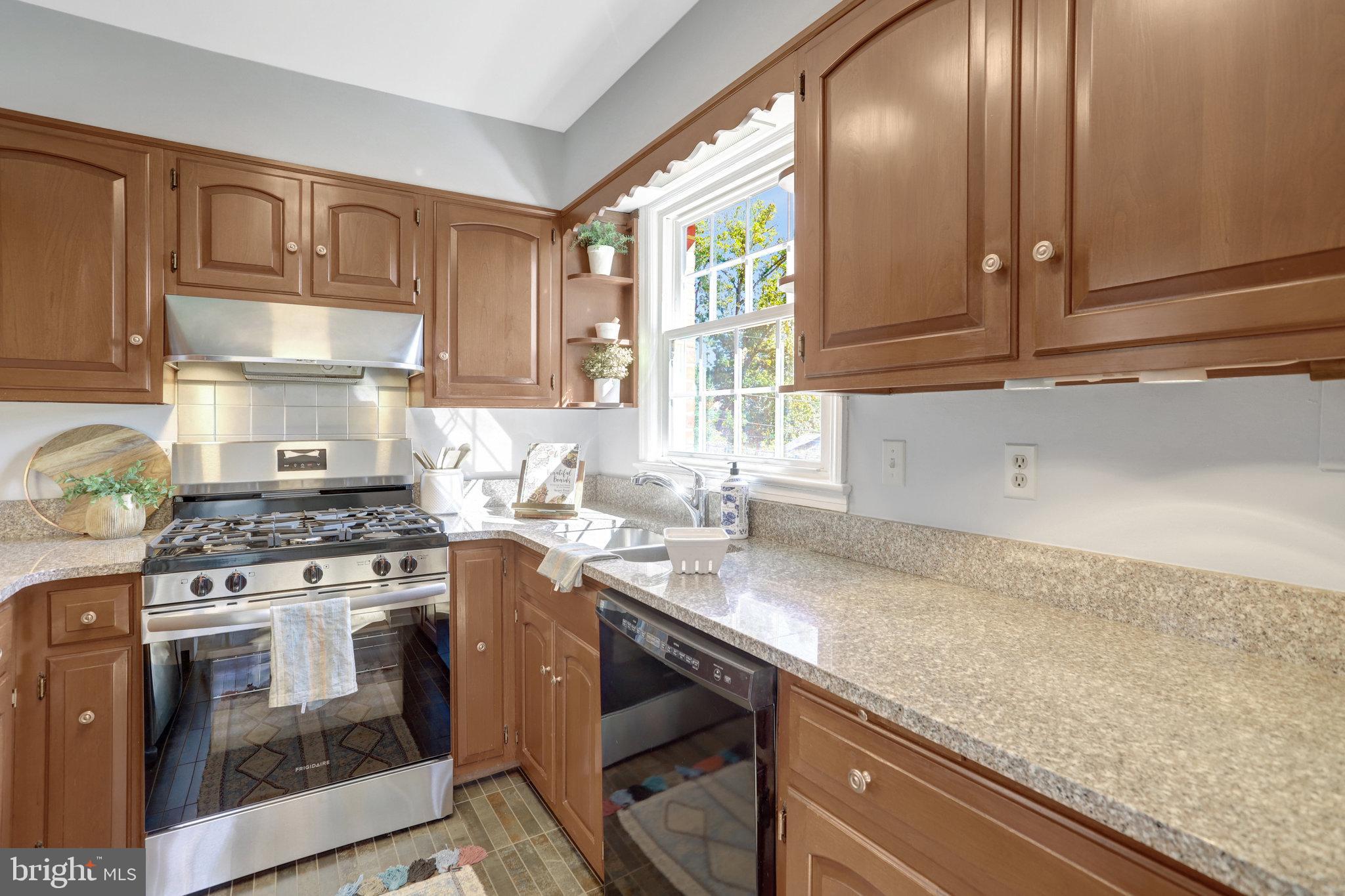 2911 Edgehill Drive Alexandria, VA 22302 - Photo 13 of 38 a kitchen with granite countertop stainless steel appliances a stove sink and cabinets