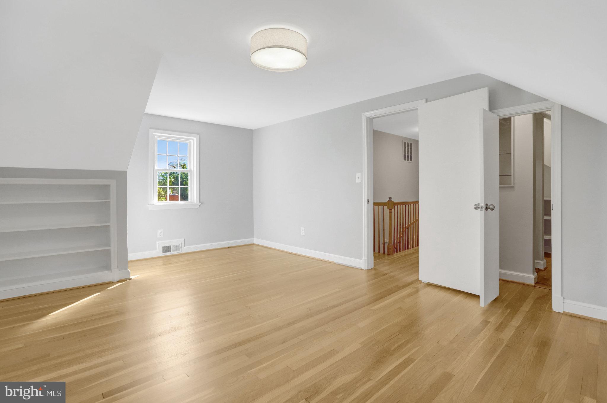 2911 Edgehill Drive Alexandria, VA 22302 - Photo 19 of 38 an empty room with wooden floor and windows