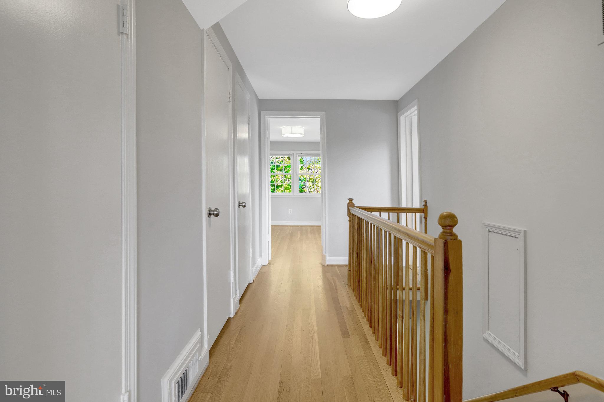 2911 Edgehill Drive Alexandria, VA 22302 - Photo 21 of 38 a view of a hallway with wooden floor and stairs