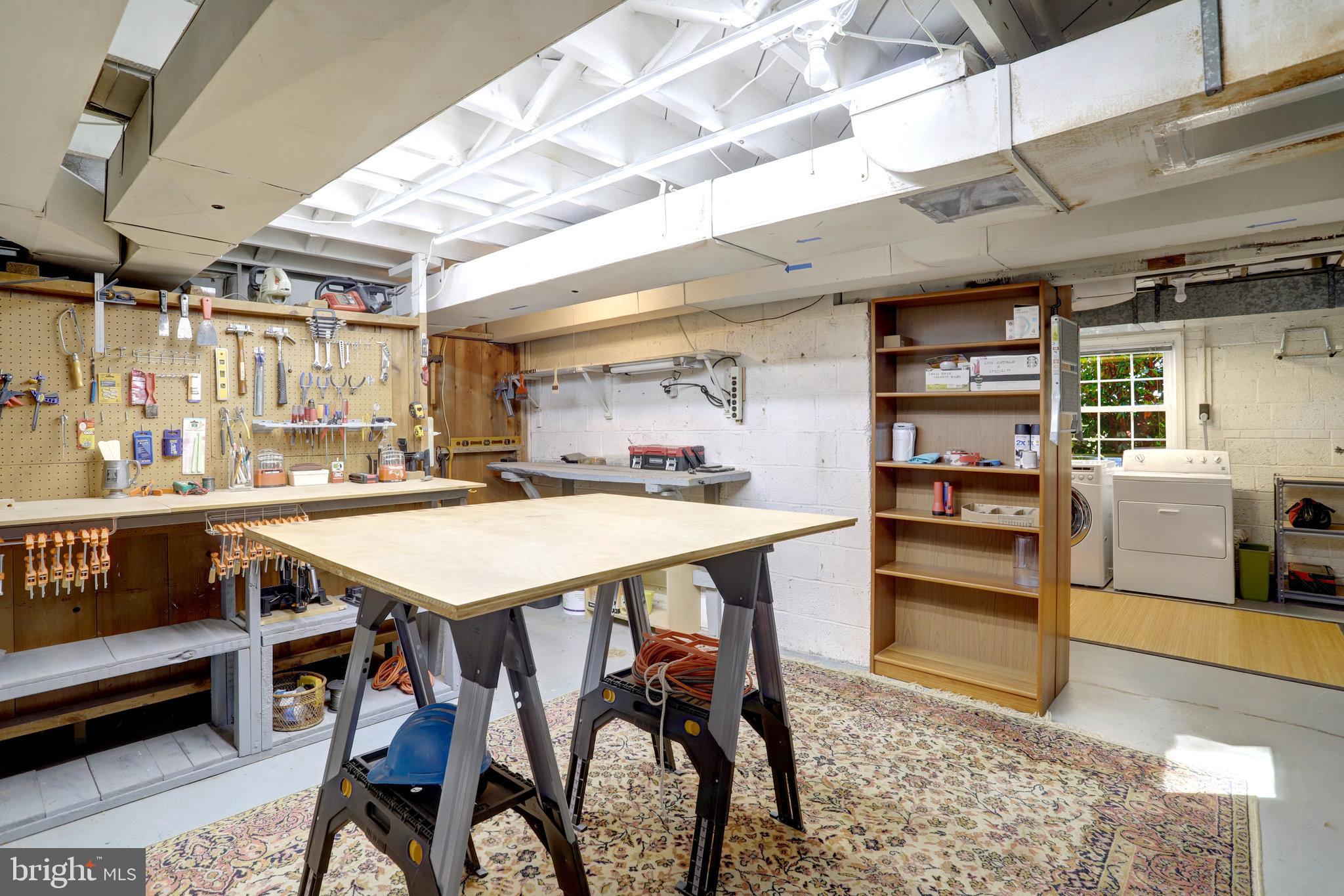 2911 Edgehill Drive Alexandria, VA 22302 - Photo 27 of 38 a dining area with stainless steel appliances kitchen island granite countertop a table chairs and a refrigerator
