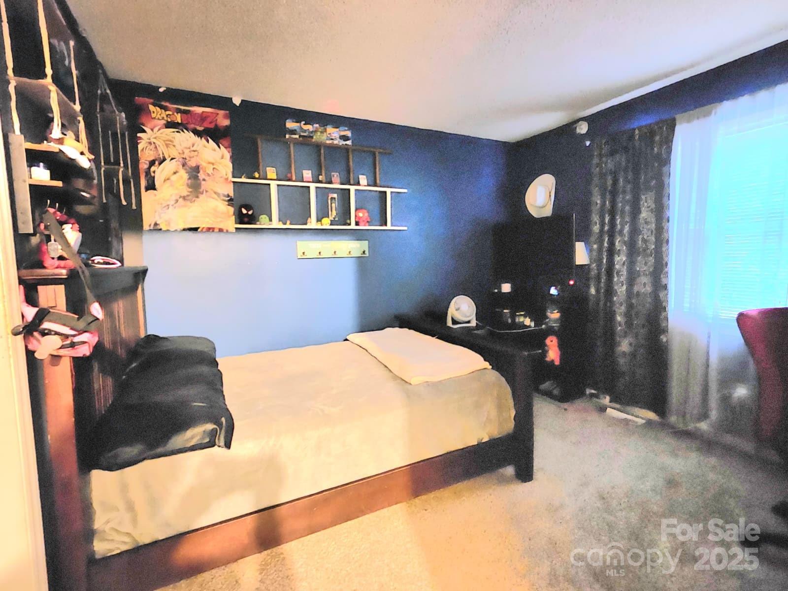 7344 Rena Mae Lane Charlotte, NC 28227 - Photo 14 of 19 a bedroom with a bed and lamp