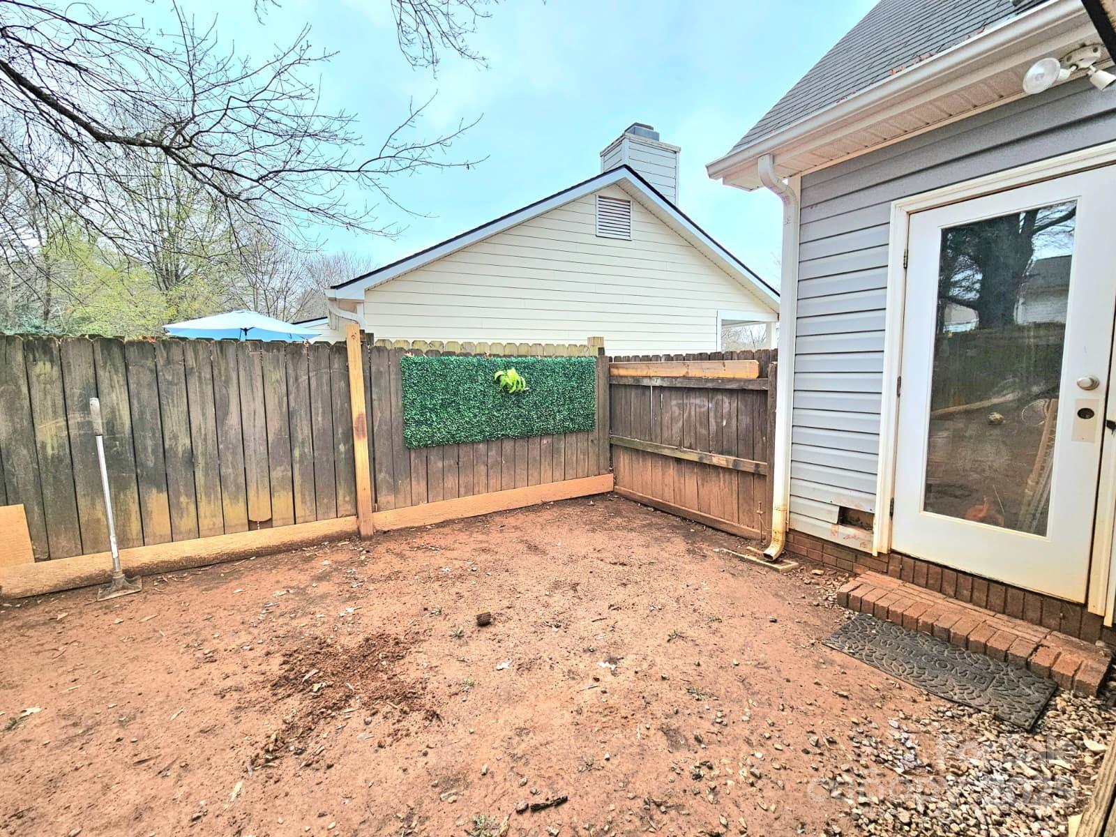 7344 Rena Mae Lane Charlotte, NC 28227 - Photo 19 of 19 a view of backyard with small cabin and wooden fence