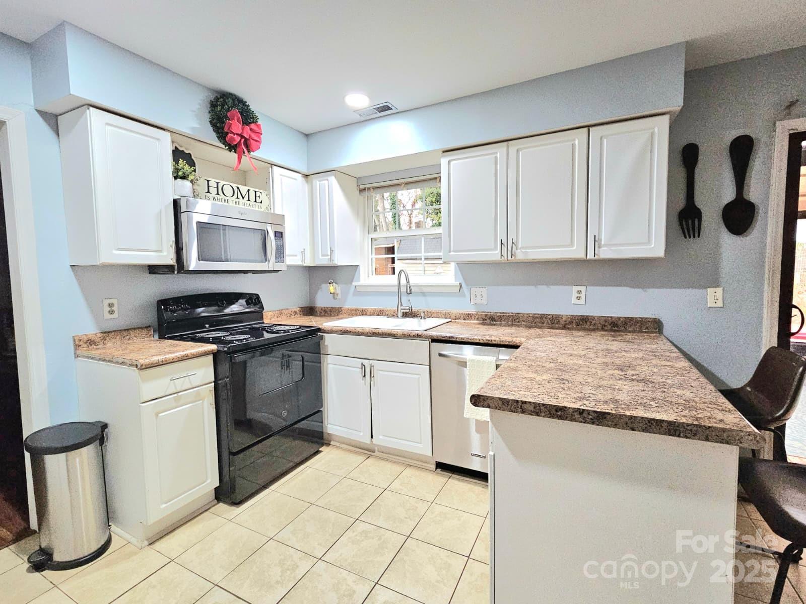 7344 Rena Mae Lane Charlotte, NC 28227 - Photo 2 of 19 a kitchen with a sink stove and cabinets