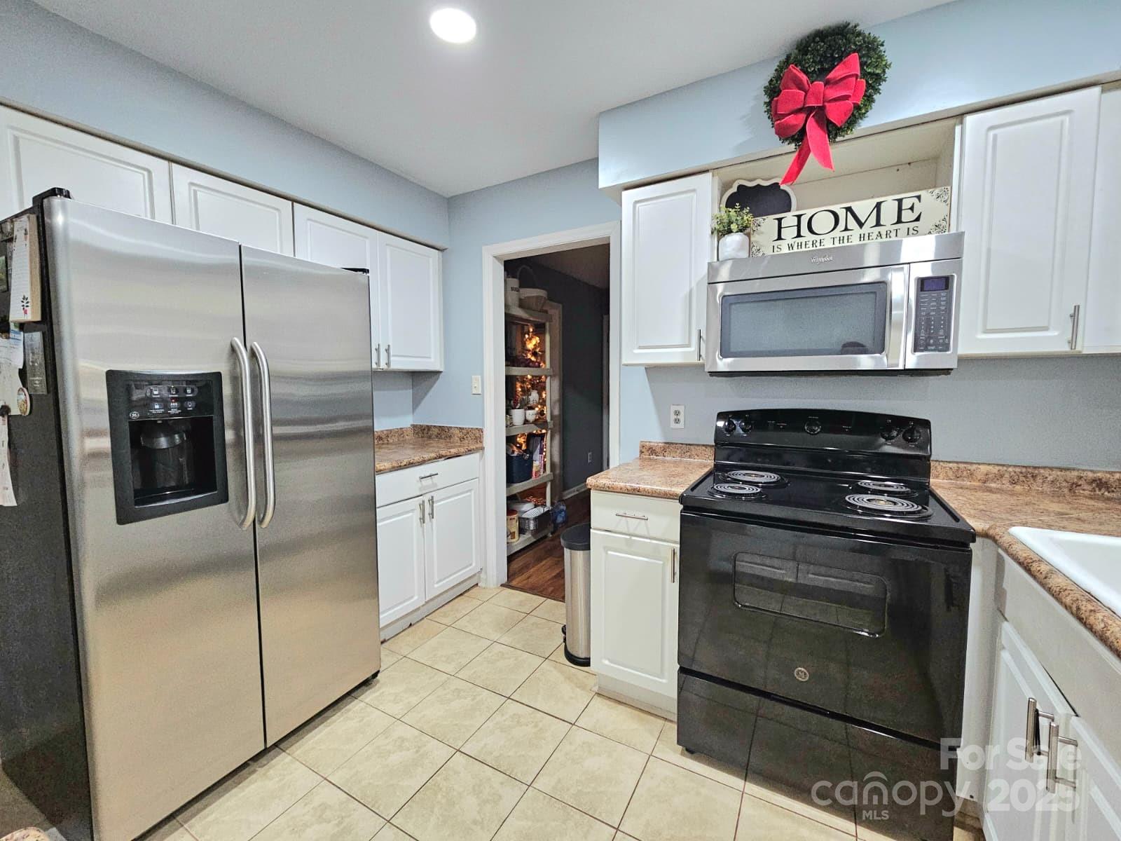 7344 Rena Mae Lane Charlotte, NC 28227 - Photo 3 of 19 a kitchen with a stove and a refrigerator