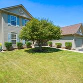 a front view of a house with yard and garage