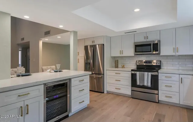 a kitchen with stainless steel appliances a stove sink and microwave