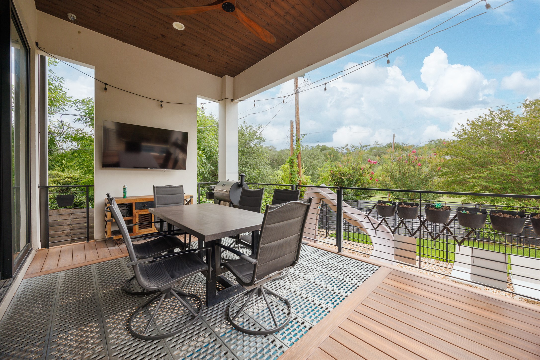 4103 Ridgelea Drive Austin, TX 78731 - Photo 4 of 26 An inviting outdoor living area with ample space for dining and enjoying scenic views.