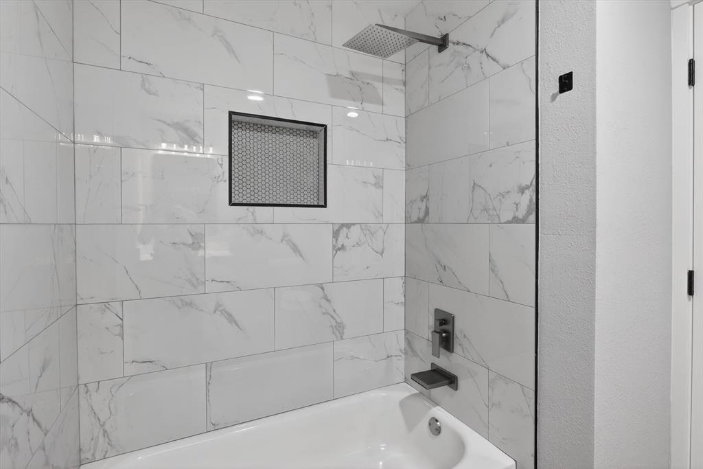 2005 Chestnut Road Carrollton, TX 75007 - Photo 20 of 35 a bathroom with a bathtub and shower