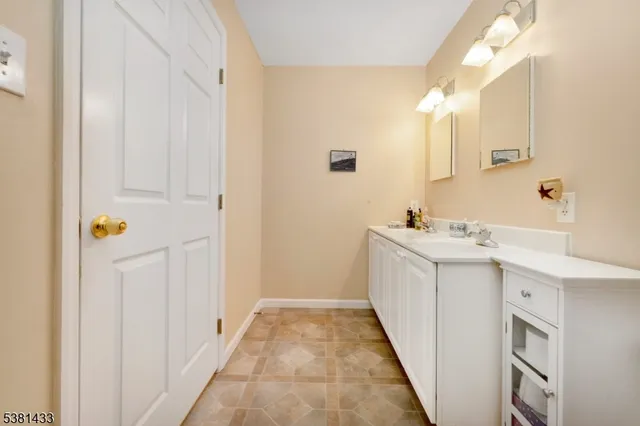a bathroom with a sink a mirror and vanity