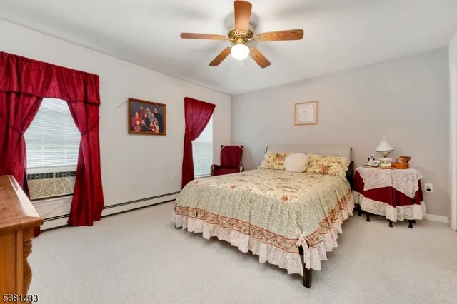 a spacious bedroom with a bed and a chandelier