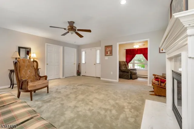 a view of a livingroom with furniture and a ceiling fan