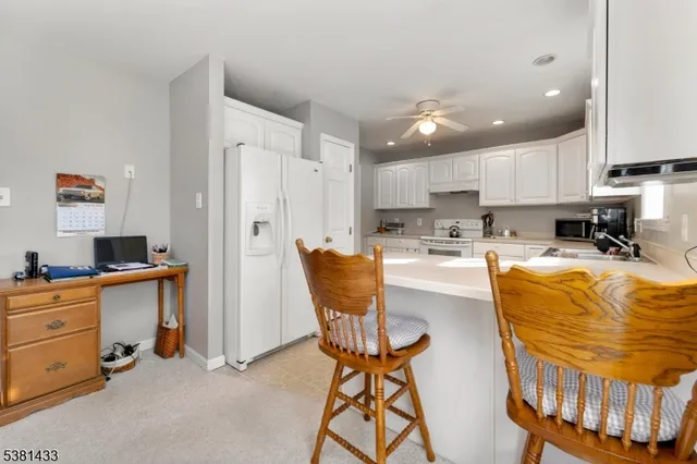 a kitchen with stainless steel appliances granite countertop a stove a sink a refrigerator and a refrigerator