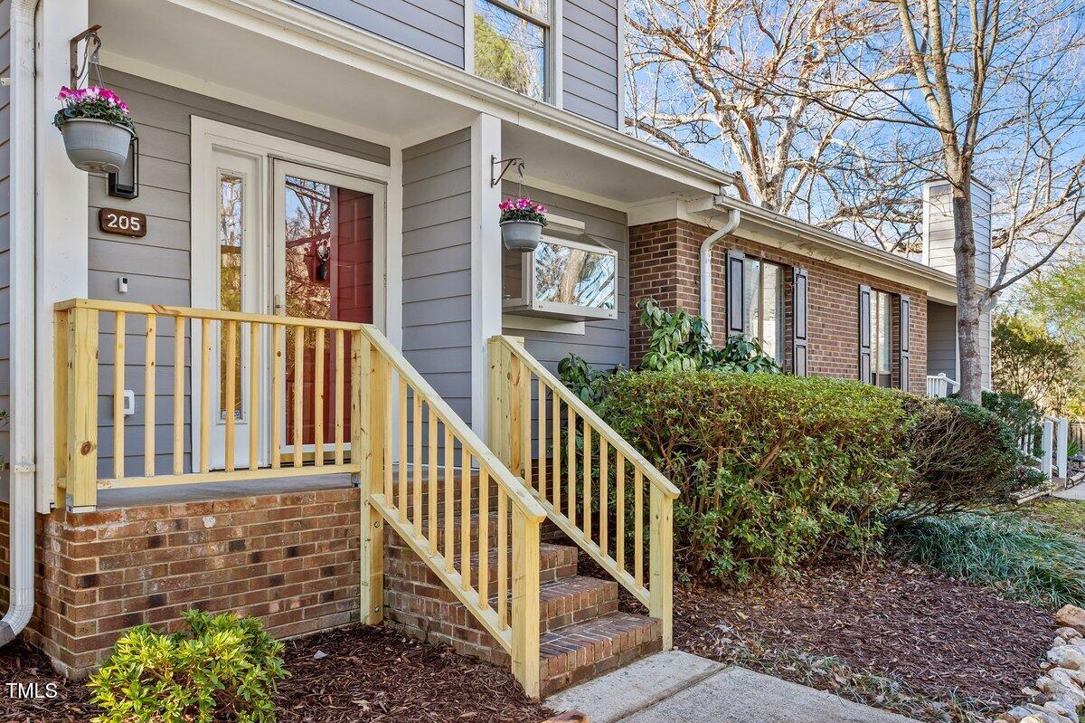 a view of a brick house with large windows