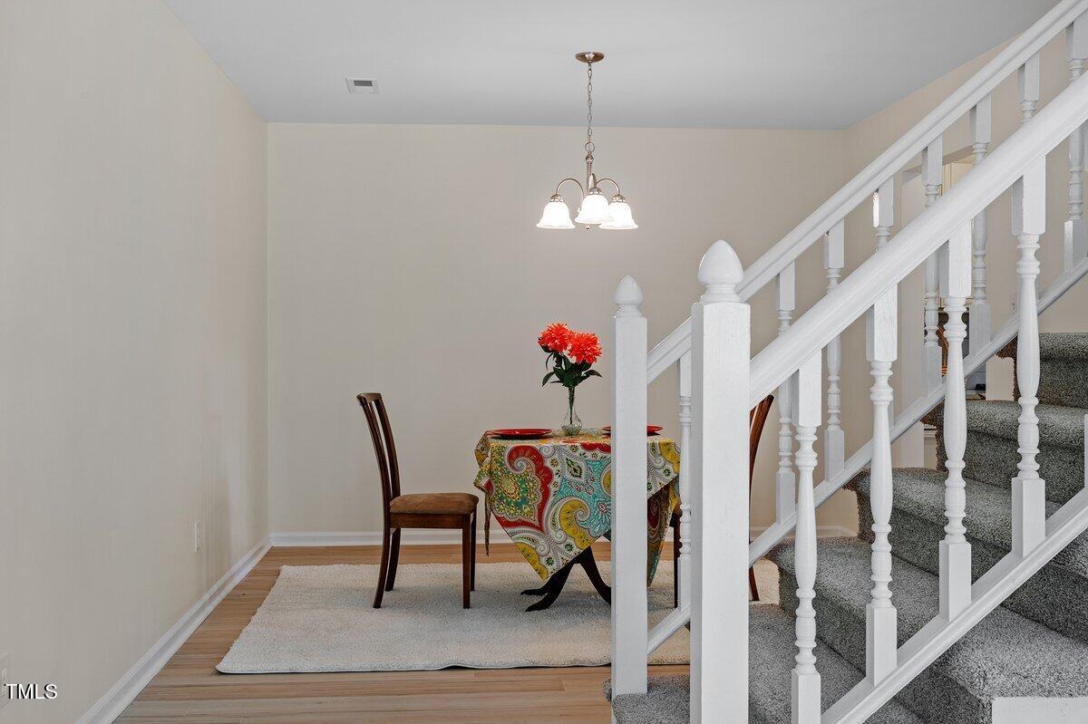 205 Clancy Circle Cary, NC 27511 - Photo 17 of 36 a view of a dining room with furniture and wooden floor
