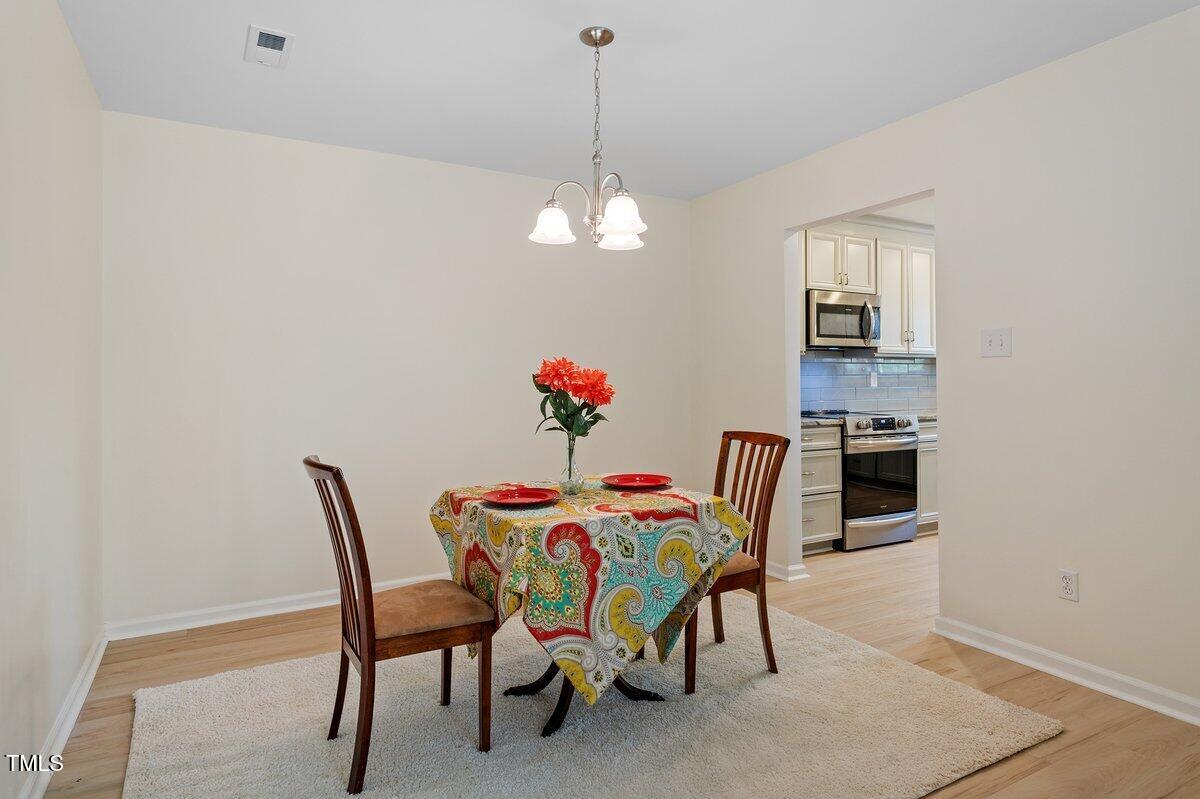 205 Clancy Circle Cary, NC 27511 - Photo 18 of 36 a dining room with furniture and chandelier