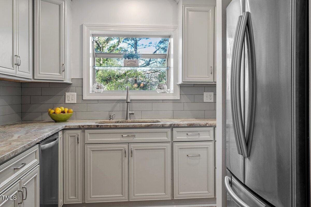 205 Clancy Circle Cary, NC 27511 - Photo 22 of 36 a kitchen with stainless steel appliances granite countertop a refrigerator sink and cabinets