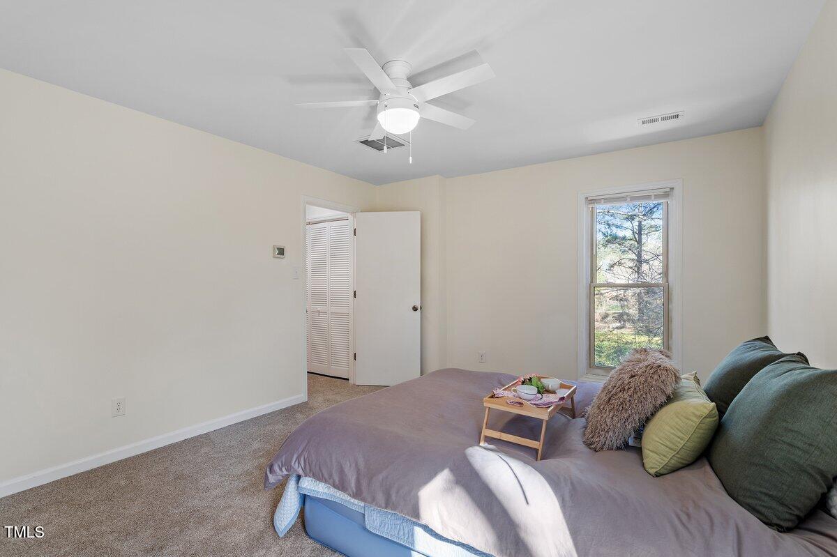 205 Clancy Circle Cary, NC 27511 - Photo 32 of 36 a bedroom with a bed and a window