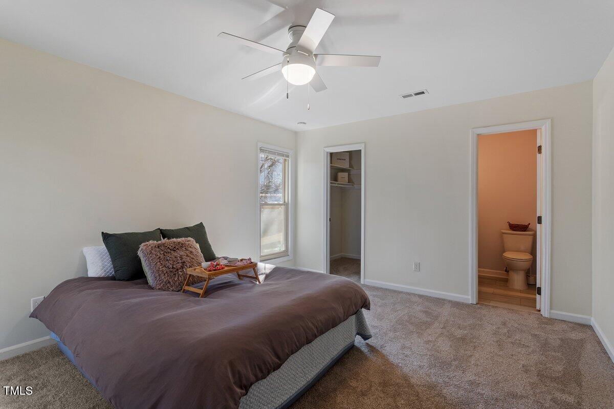 205 Clancy Circle Cary, NC 27511 - Photo 33 of 36 a bedroom with a bed and a ceiling fan