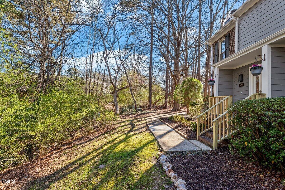 205 Clancy Circle Cary, NC 27511 - Photo 3 of 36 a view of a house with large trees and a yard