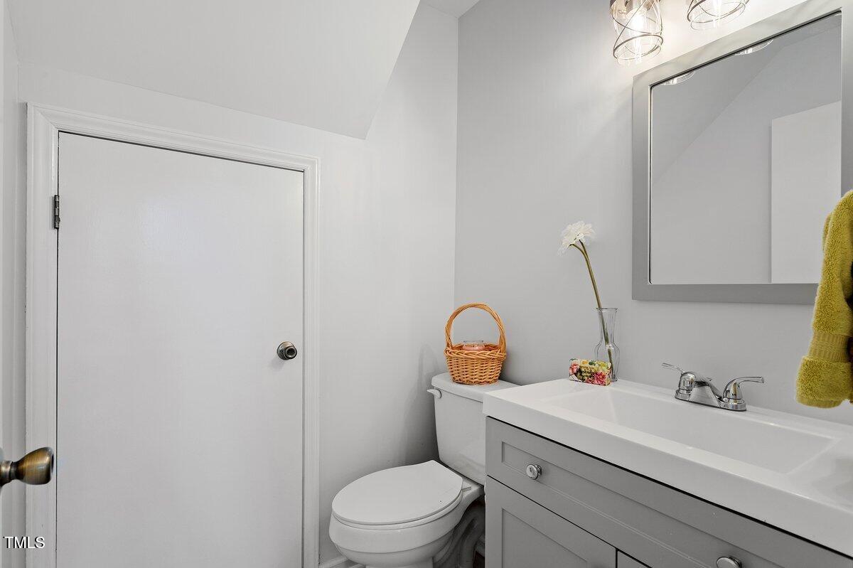 205 Clancy Circle Cary, NC 27511 - Photo 9 of 36 a bathroom with a sink a toilet and vanity