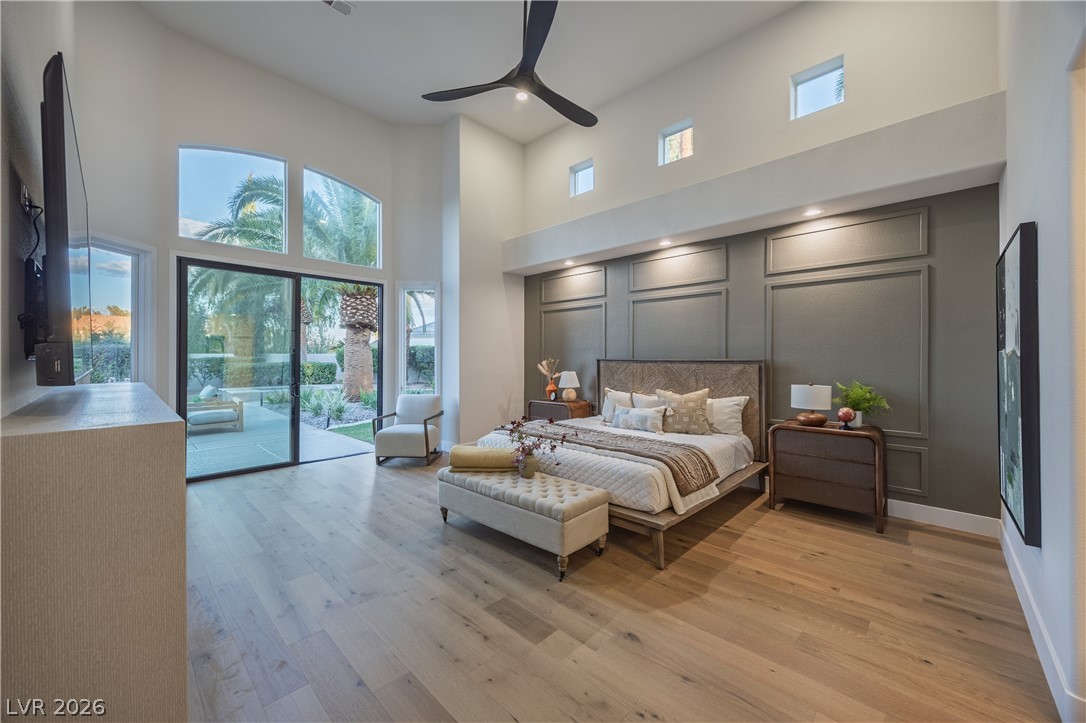 8800 Lusso Las Vegas, NV 89134 - Photo 39 of 85 Bedroom featuring light wood-type flooring, a high ceiling, access to exterior, ceiling fan, and recessed lighting