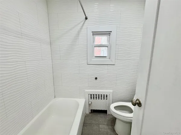a white toilet sitting next to a bathroom sink