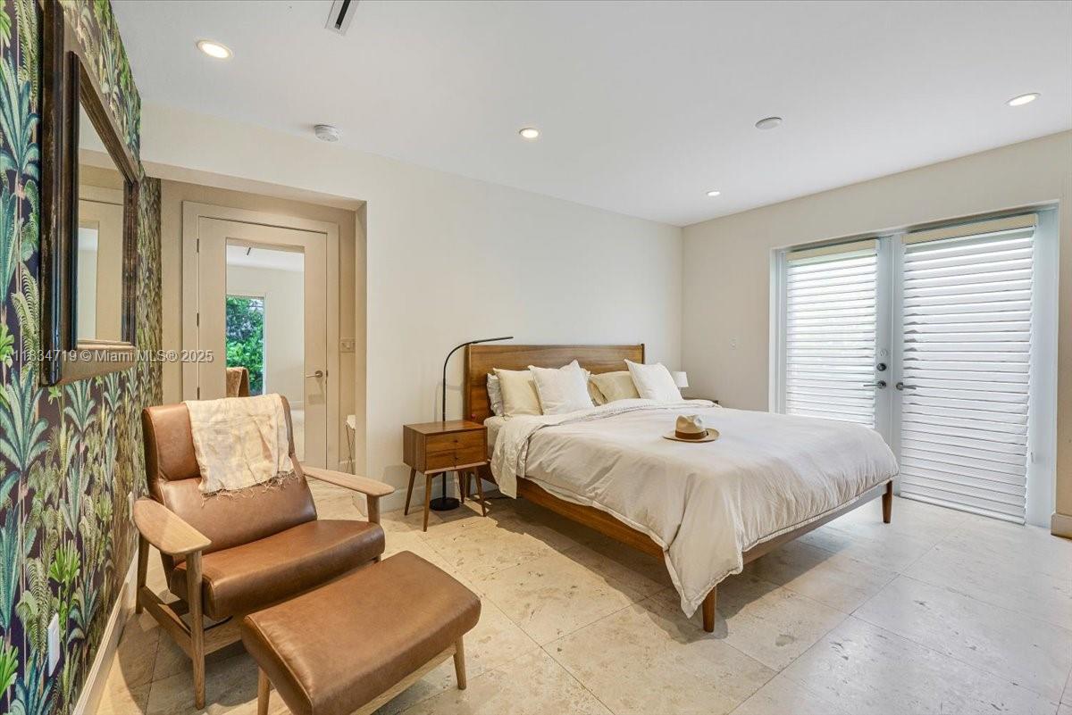 435 Ridgewood Road Key Biscayne, FL 33149 - Photo 13 of 32 a bedroom with a bed and a couch