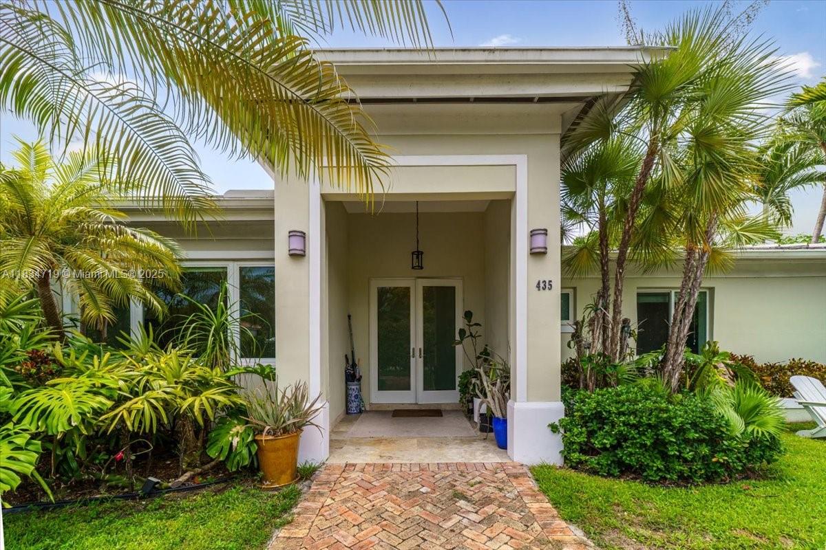 435 Ridgewood Road Key Biscayne, FL 33149 - Photo 2 of 32 a view of a house with a small garden