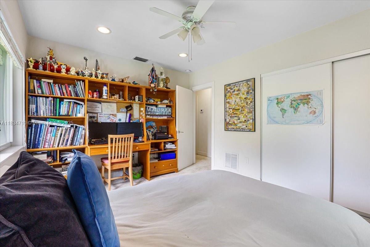 435 Ridgewood Road Key Biscayne, FL 33149 - Photo 21 of 32 a view of a bedroom with workspace and toys