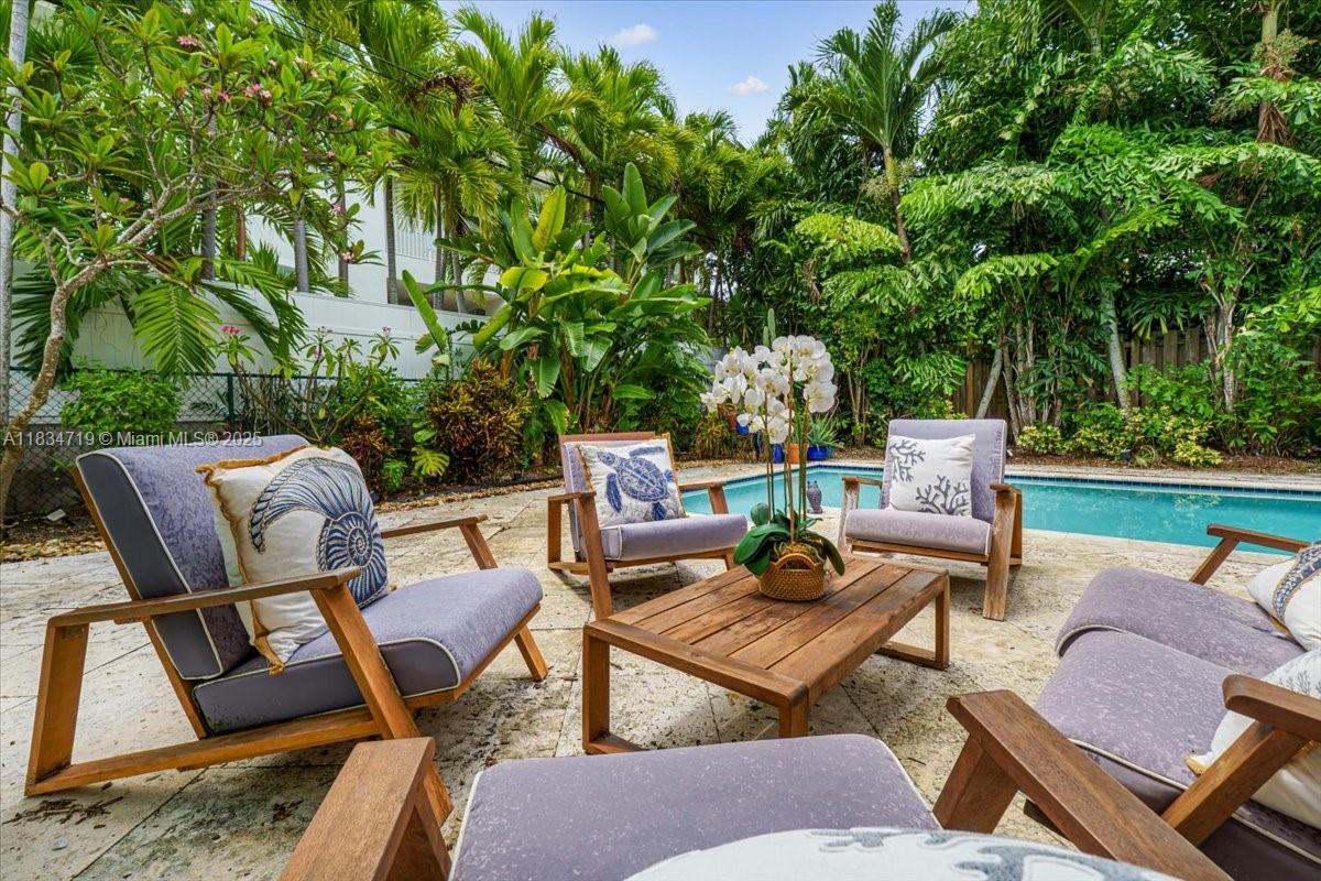 435 Ridgewood Road Key Biscayne, FL 33149 - Photo 27 of 32 a backyard of a house with outdoor seating