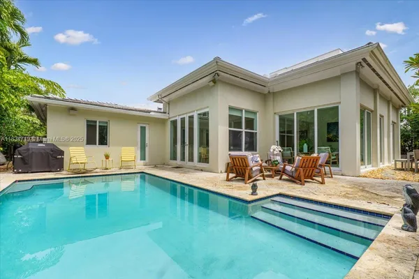 an aerial view of a house with a yard and garden