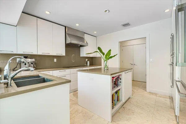 a kitchen with stainless steel appliances granite countertop a sink and a stove
