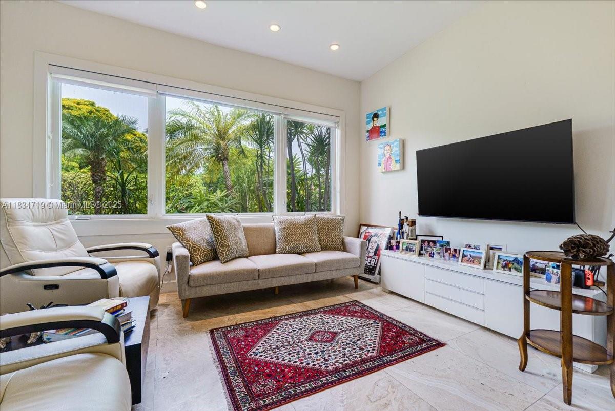 435 Ridgewood Road Key Biscayne, FL 33149 - Photo 10 of 32 a living room with furniture and a flat screen tv
